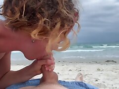 Deep blowjob on the beach, female in swimsuit sucking cock, cum mouth outdoors